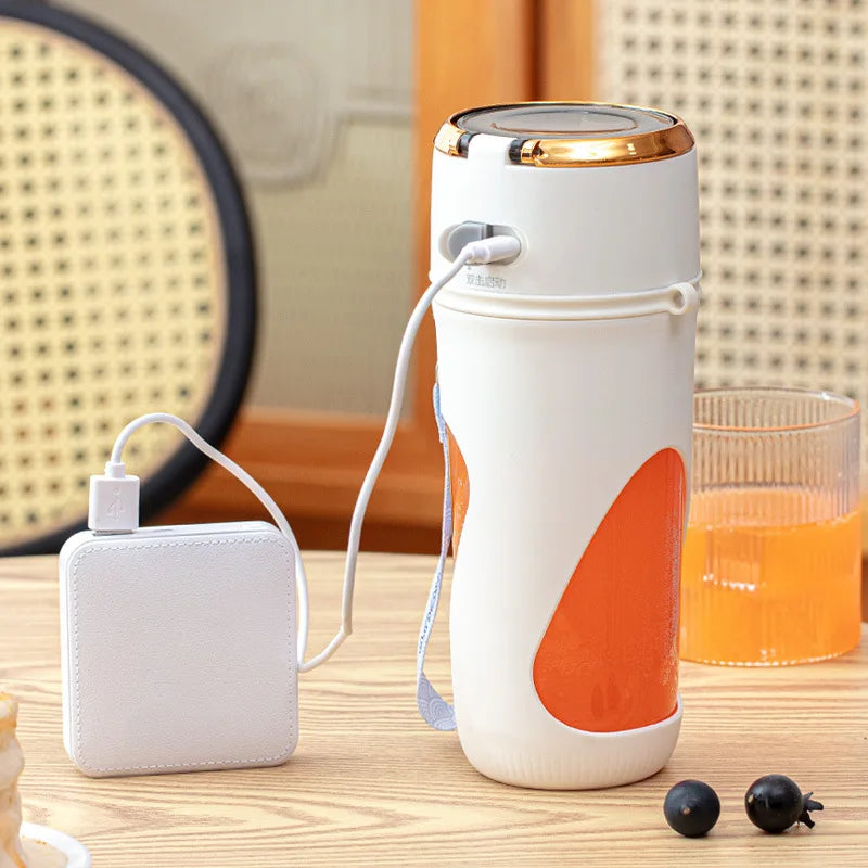 a white and orange portable blender sitting on top of a table