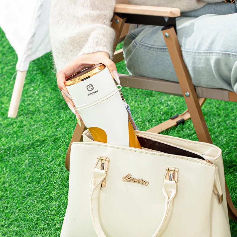 a woman sitting in a chair holding a white purse